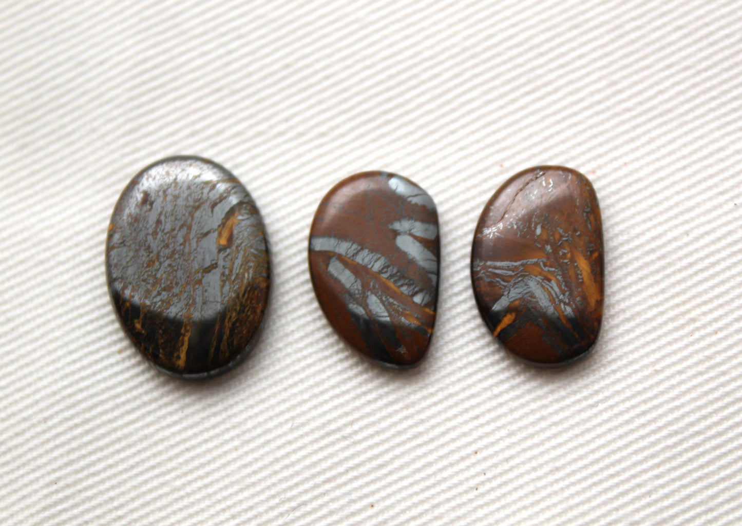 Lot of three THIN cabochons of Hematite Tiger Eye freeform