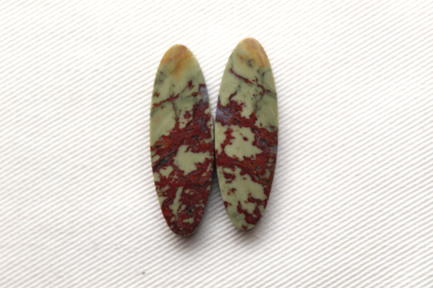 Matching pair of Red Fiber Jasper Cabochons oval green