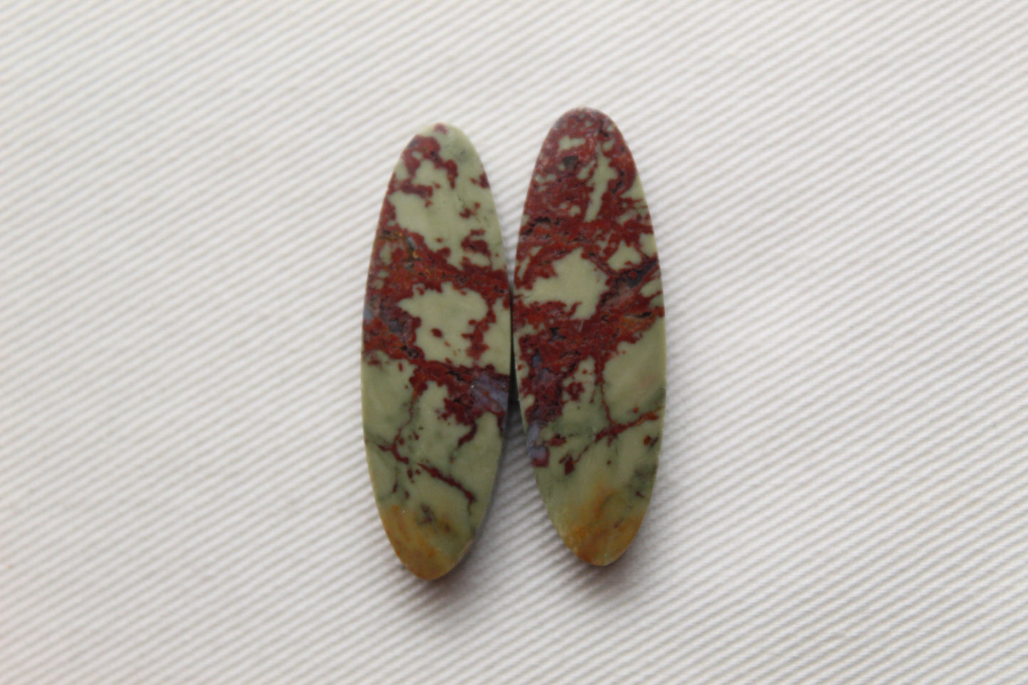 Matching pair of Red Fiber Jasper Cabochons oval green