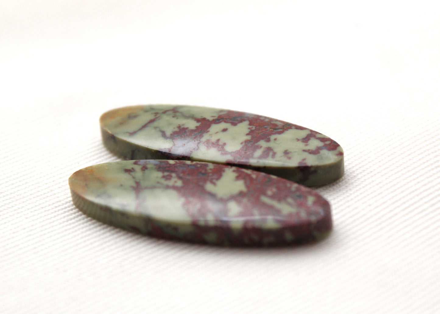 Matching pair of Red Fiber Jasper Cabochons oval green