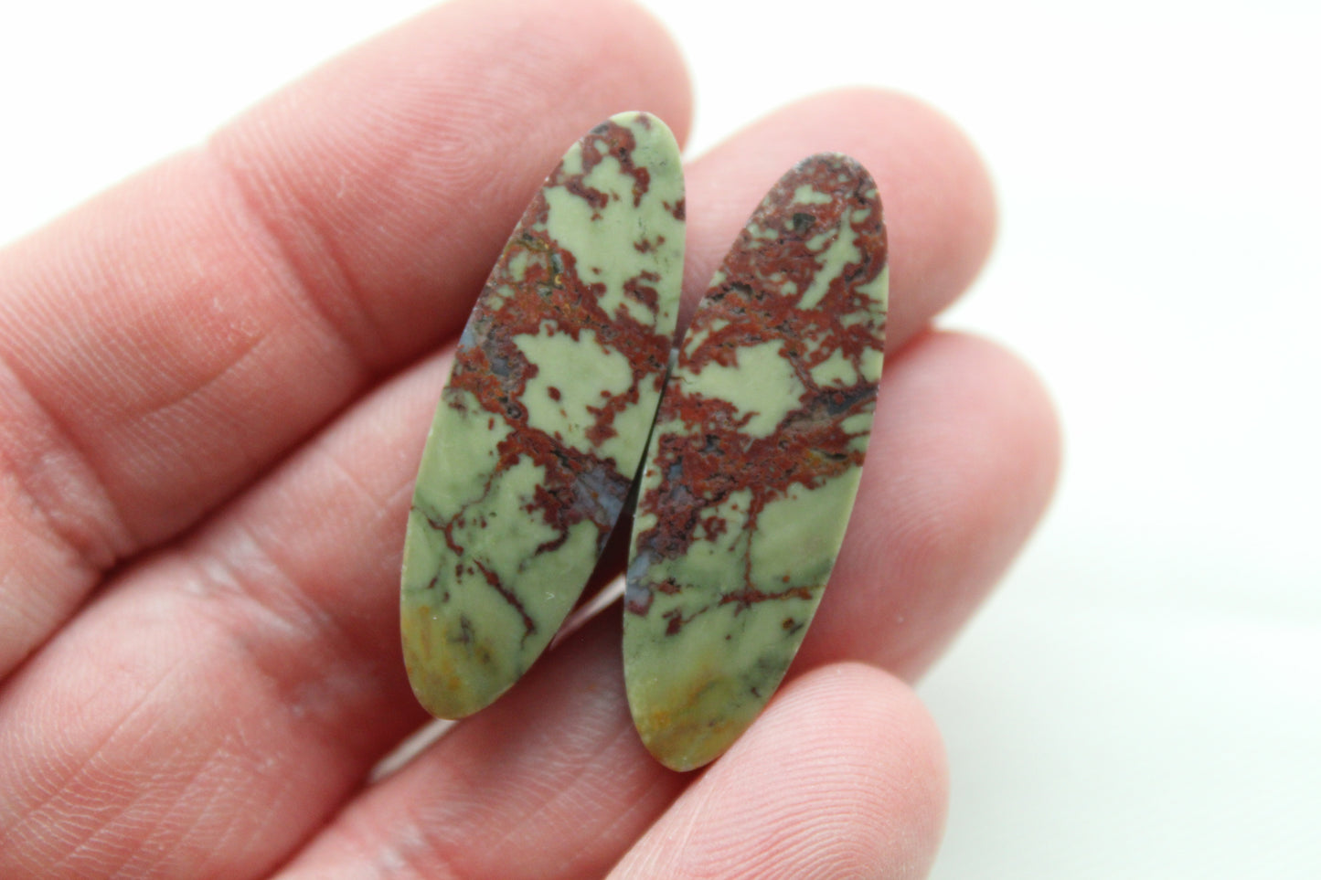 Matching pair of Red Fiber Jasper Cabochons oval green