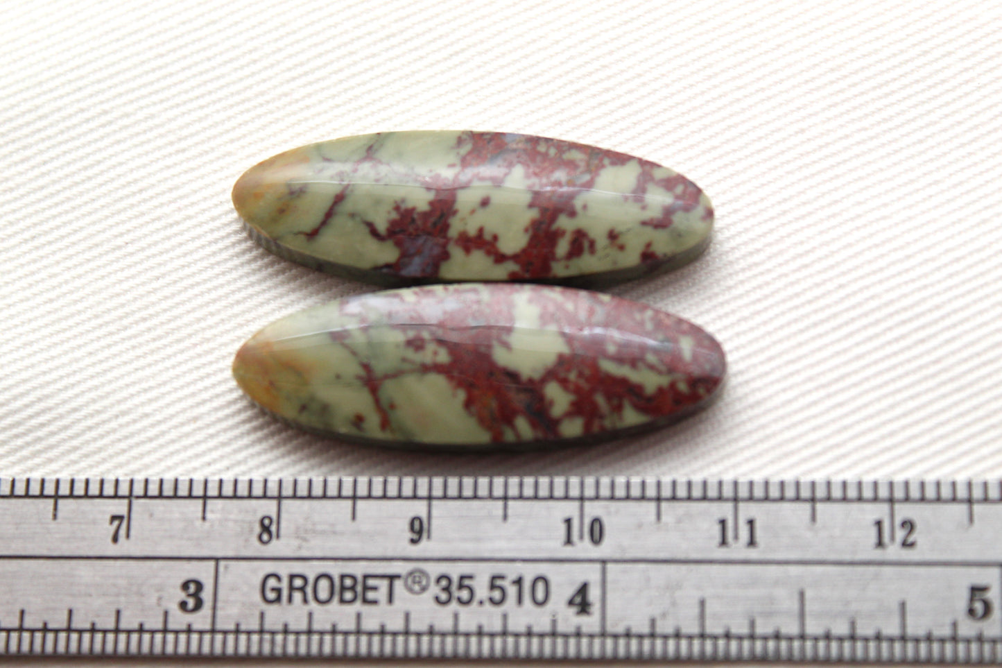Matching pair of Red Fiber Jasper Cabochons oval green