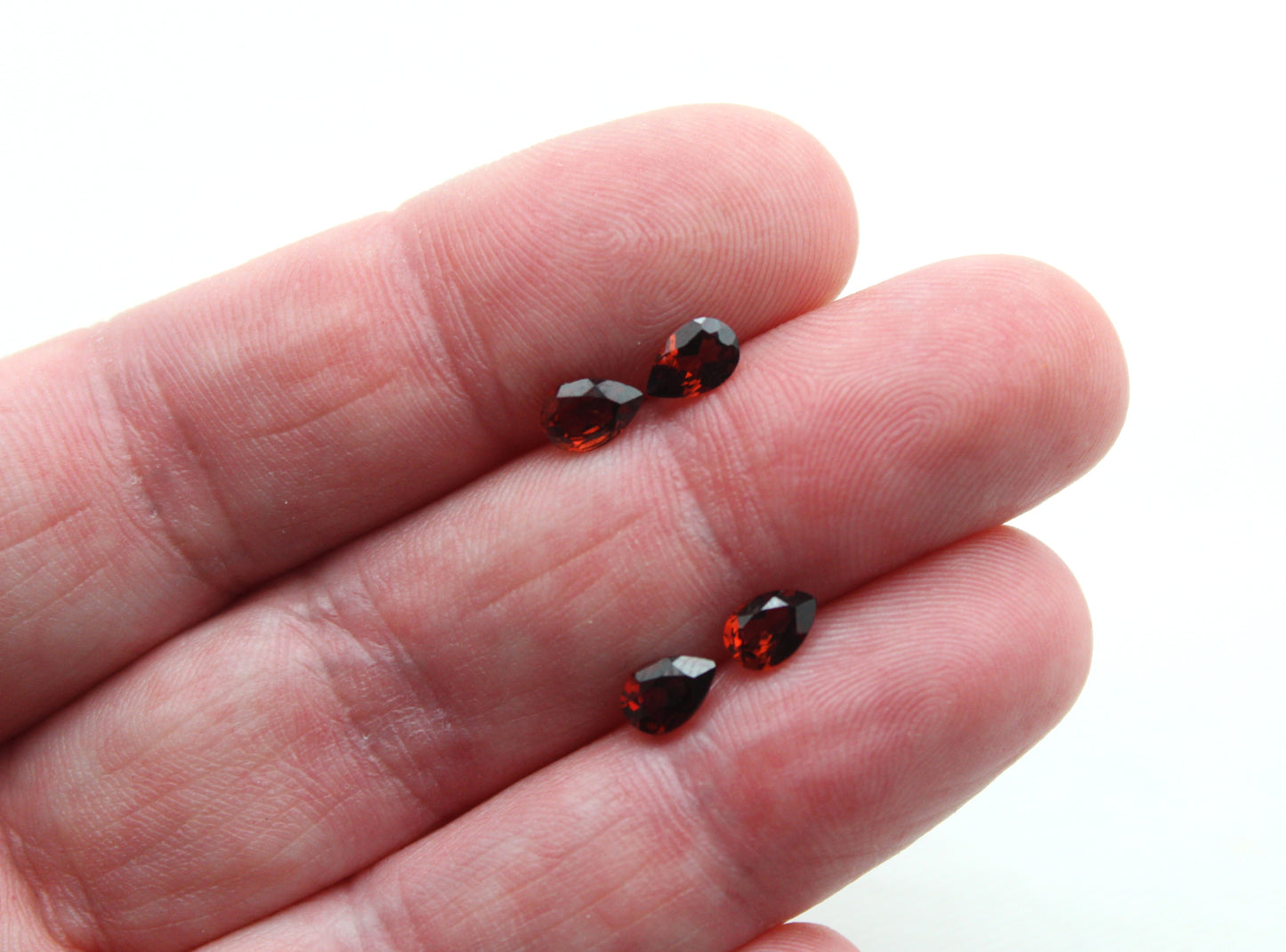 FOUR faceted red Garnet gemstones pear 6X4MM