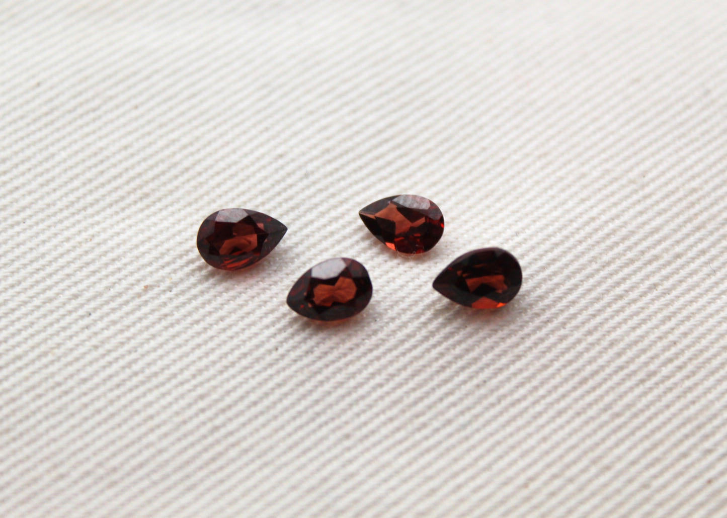 FOUR faceted red Garnet gemstones pear 6X4MM