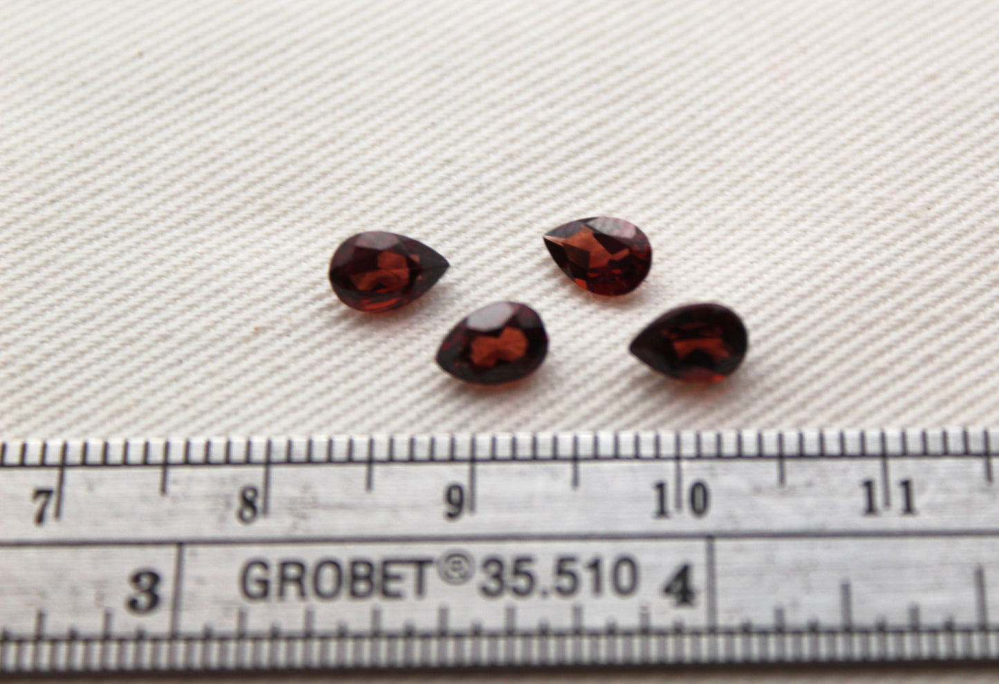 FOUR faceted red Garnet gemstones pear 6X4MM