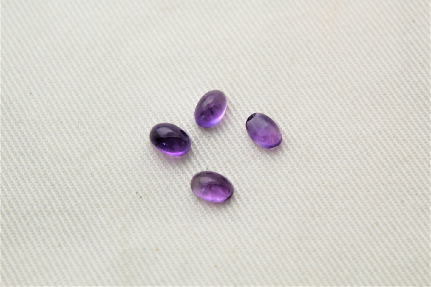 FOUR tiny amethyst oval cabochons 6X4MM