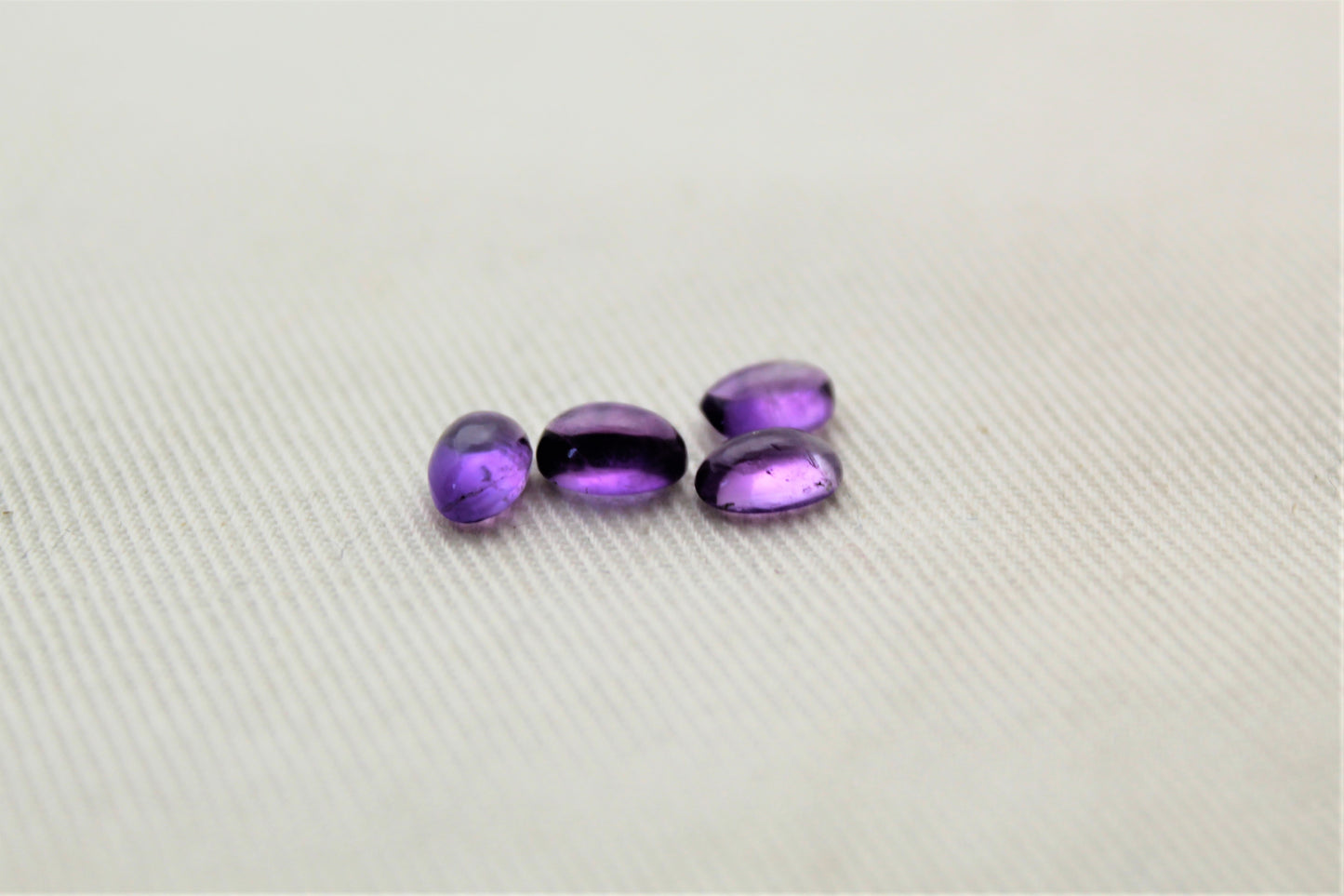 FOUR tiny amethyst oval cabochons 6X4MM